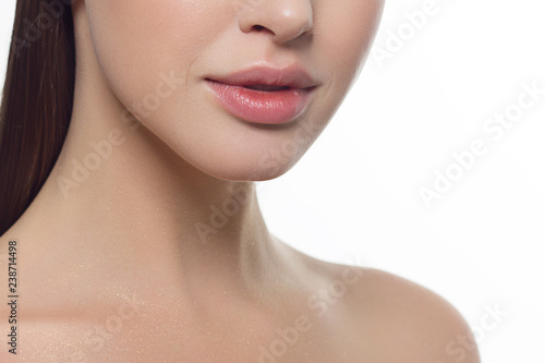 Closeup of beautiful female mouth with natural lip makeup.