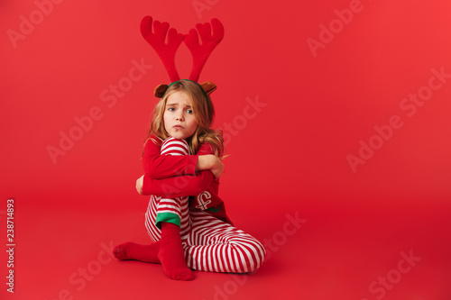Upset little girl wearing Christmas raindeer costume