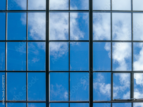 Blue sky with white clouds through the window in the ceiling of a large building
