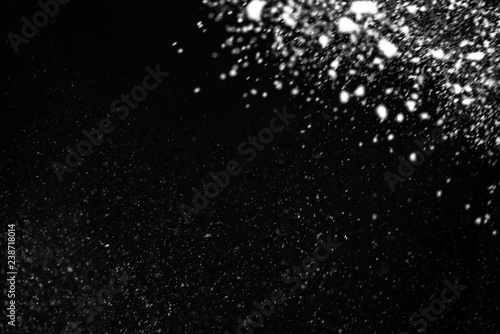 Falling snow on a black background. Snowfall weather. Texture for overlay