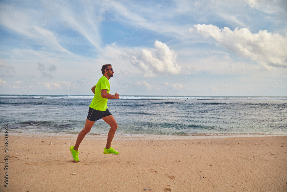 Man running / jogging on a tropical exotic beach. Man running / jogging on a tropical exotic beach.