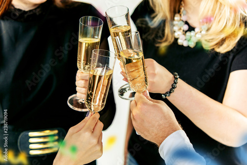 Celebration. Hands holding the glasses of champagne and wine making a toast. The party, celebration, alcohol, lifestyle, friendship, holiday, christmas, new, year and clinking concept © master1305