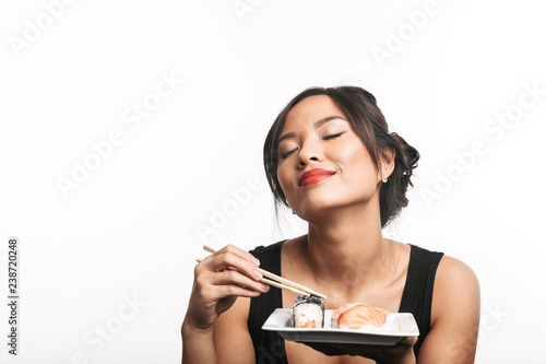 Pretty happy asian woman sitting at the table