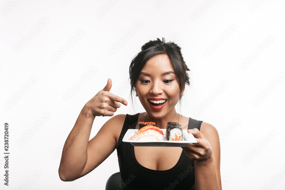 Beautiful young asian woman holding plate with sushi set