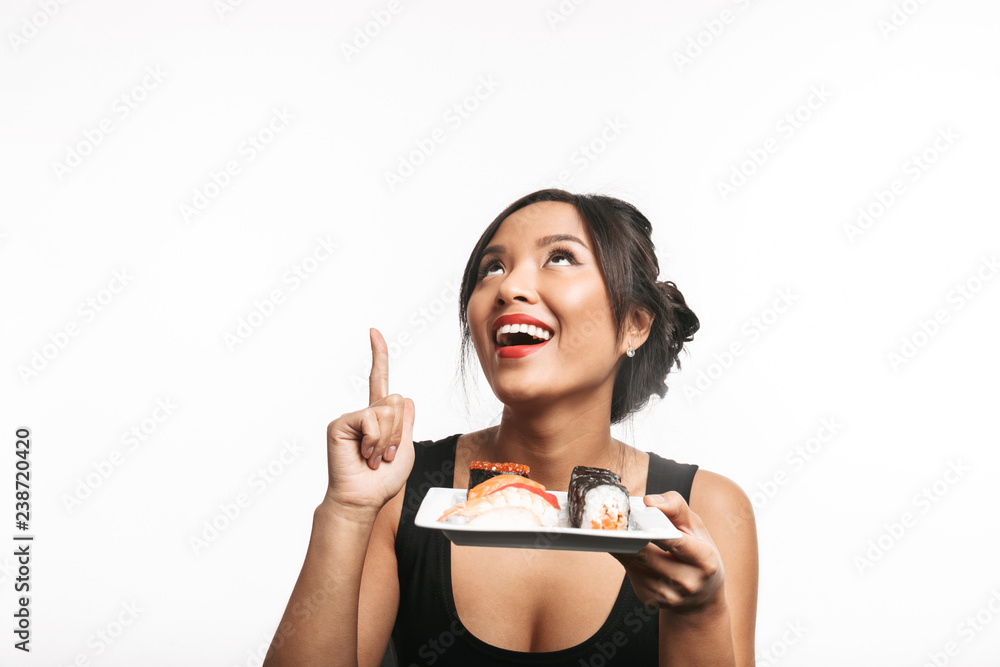 Beautiful young asian woman holding plate with sushi set Beautiful young asian woman holding plate with sushi set