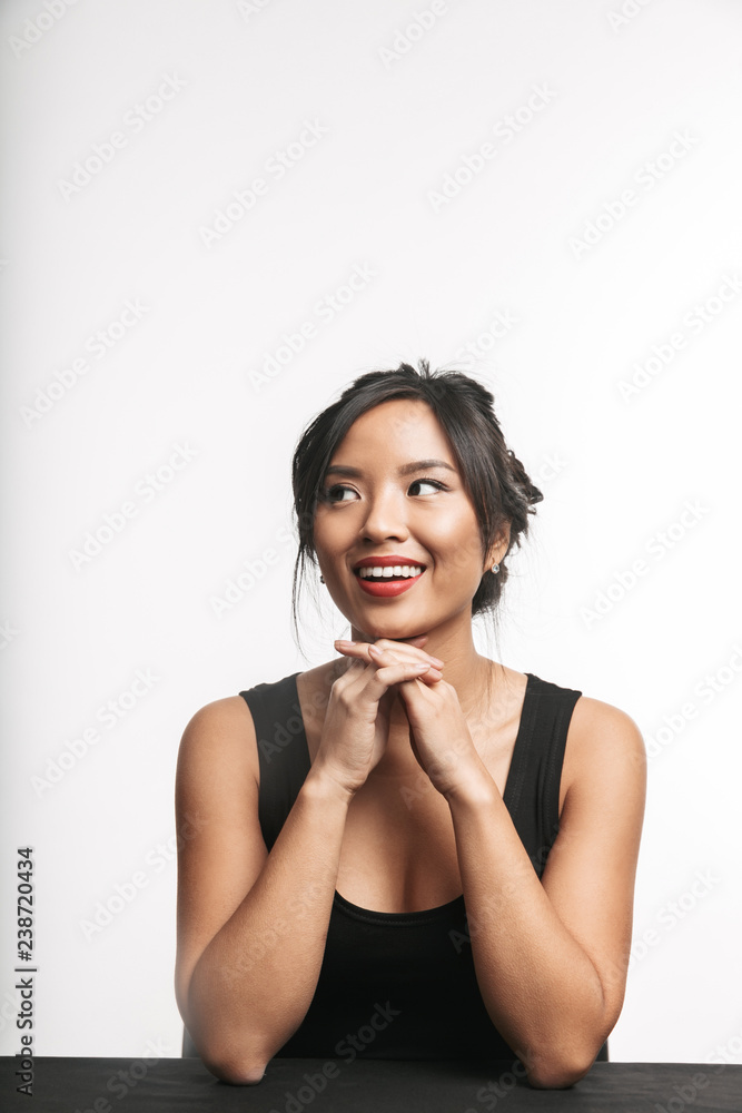 Pretty young asian woman sitting at the table Pretty young asian woman sitting at the table