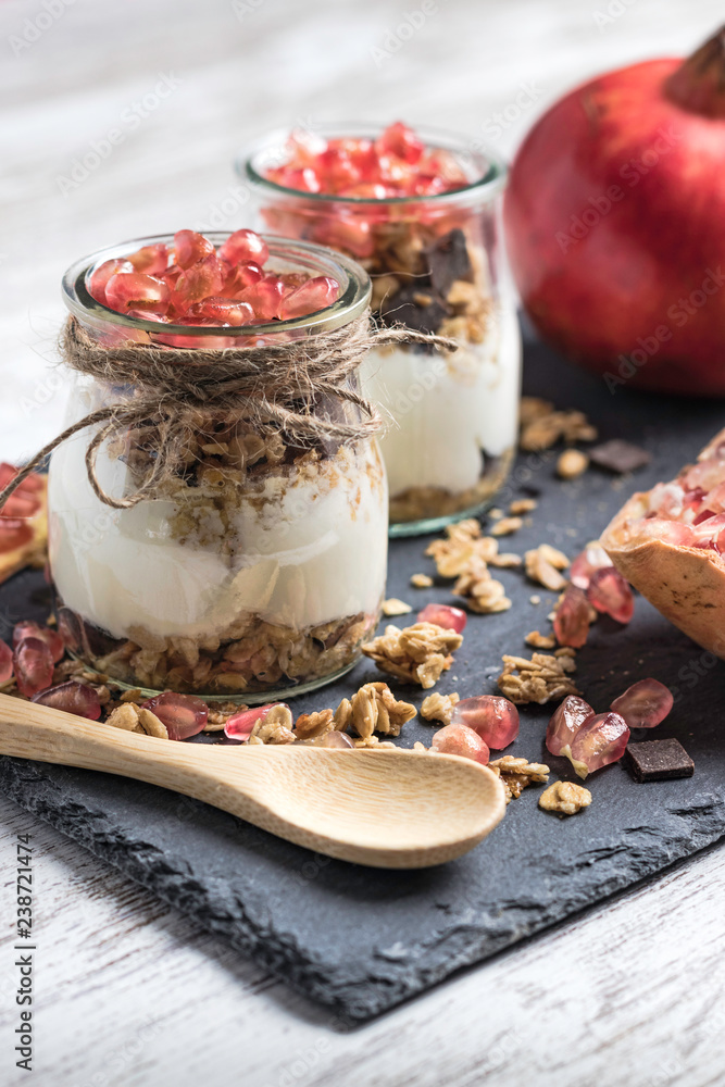 Yogurt pots with cereals and pomegranate