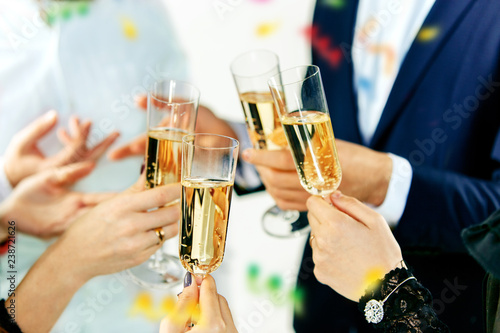 Celebration. Hands holding the glasses of champagne and wine making a toast. The party  alcohol  lifestyle  friendship  holiday  christmas  new  year and clinking concept