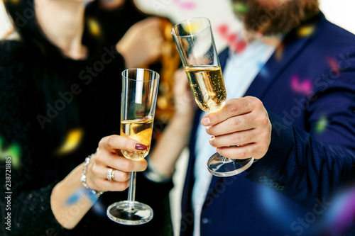Celebration. Hands holding the glasses of champagne and wine making a toast. The party, alcohol, lifestyle, friendship, holiday, christmas, new, year and clinking concept