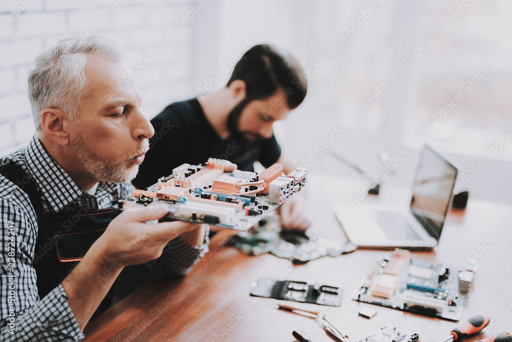 Two Men Repairing Hardware Equipment from PC. Two Men Repairing Hardware Equipment from PC.