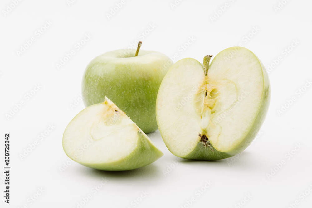 cut and whole delicious green apples on white background cut and whole delicious green apples on white background