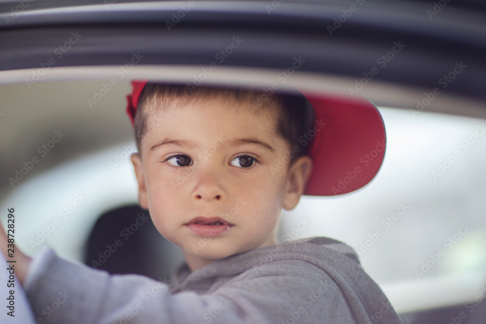 Portrait little boy in the car.