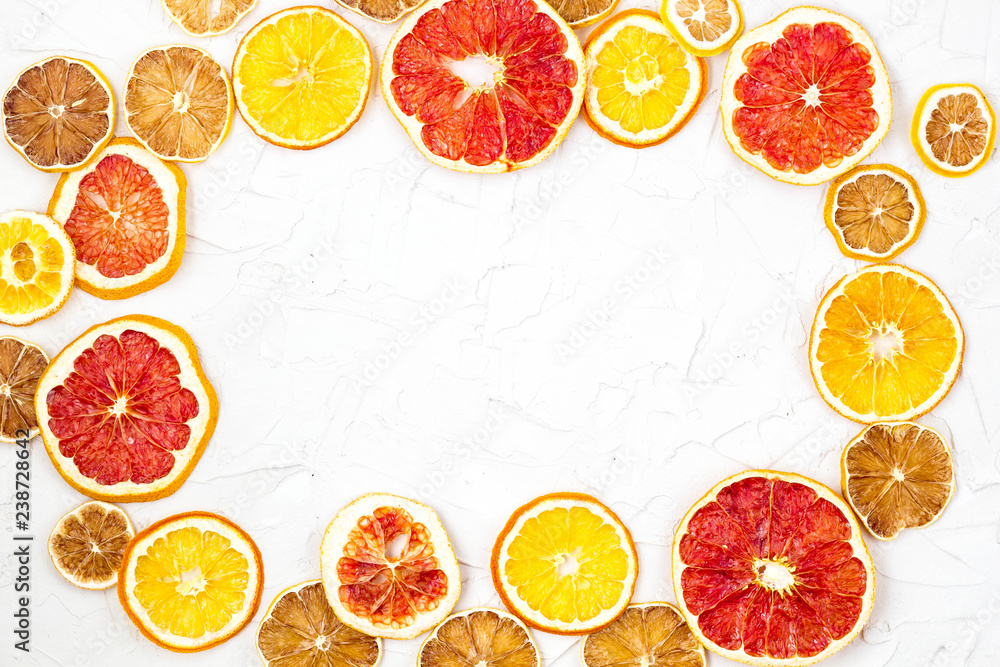 Border of Dried slices of various citrus fruits on white background. Orange lemon grapefruit with copyspace Border of Dried slices of various citrus fruits on white background. Orange lemon grapefruit with copyspace