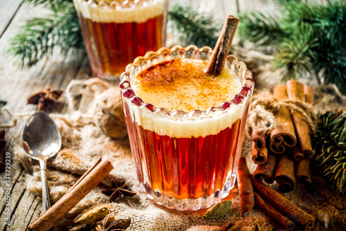 Photo Winter holidays traditional drink, homemade hot buttered rum with spices, over o