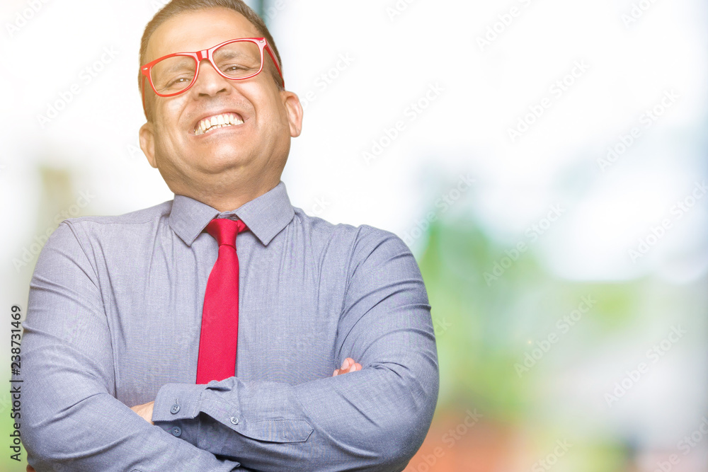 Middle age arab man wearing fashion red glasses over isolated background happy face smiling with crossed arms looking at the camera. Positive person. Middle age arab man wearing fashion red glasses over isolated background happy face smiling with crossed arms looking at the camera. Positive person.