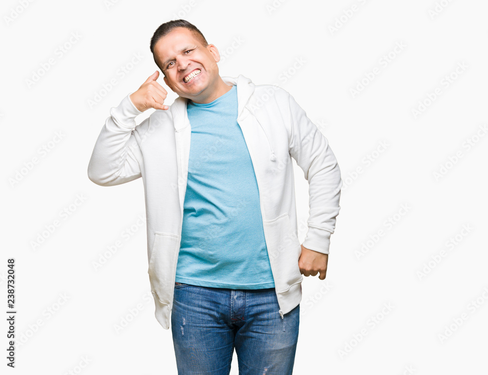 Middle age arab man wearing sweatshirt over isolated background smiling doing phone gesture with hand and fingers like talking on the telephone. Communicating concepts. Middle age arab man wearing sweatshirt over isolated background smiling doing phone gesture with hand and fingers like talking on the telephone. Communicating concepts.