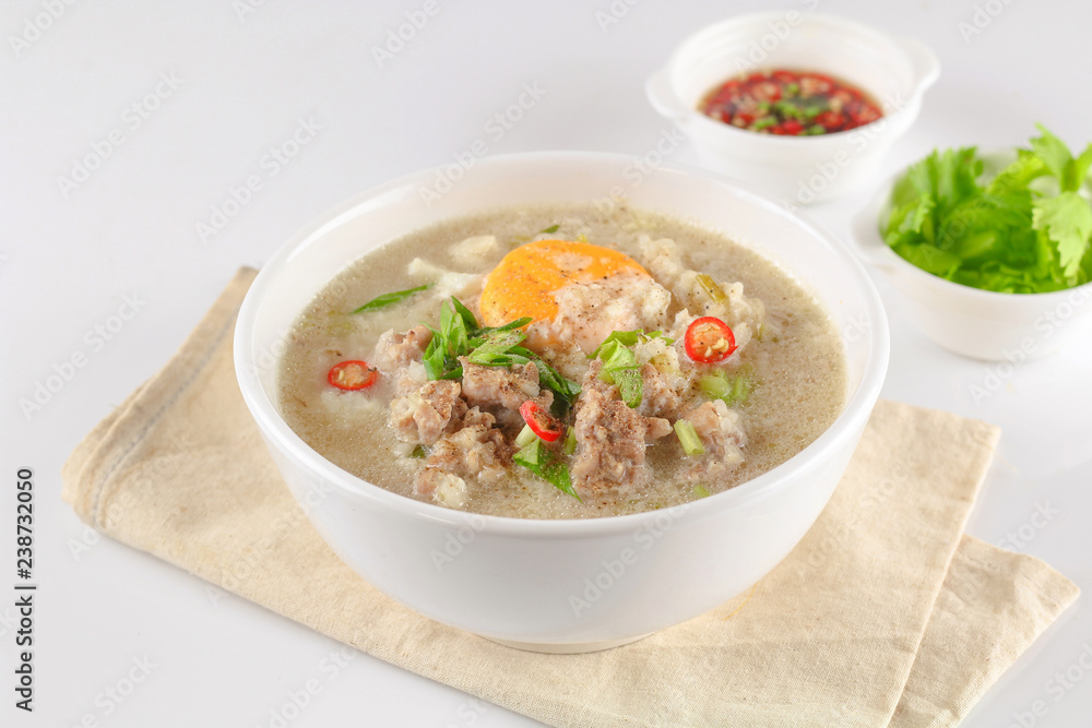 Congee with minced pork and boiled egg in bowl Congee with minced pork and boiled egg in bowl