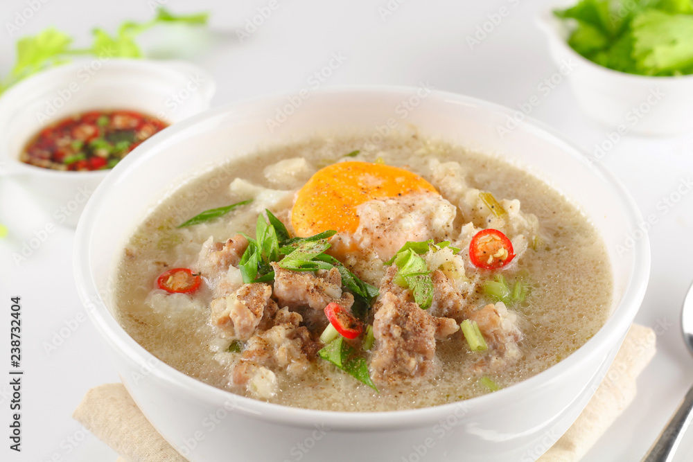 Congee with minced pork and boiled egg in bowl