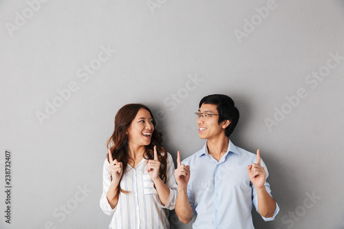 Cheerful asian business couple standing