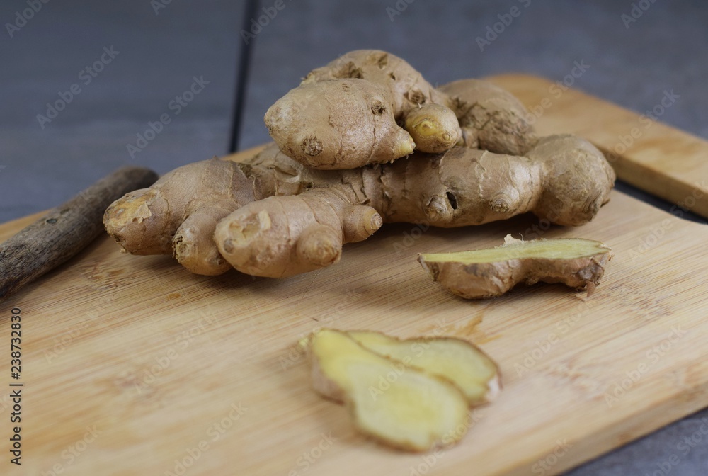 Große, frische Ingwerknolle auf einem Holzbrettchen Große, frische Ingwerknolle auf einem Holzbrettchen