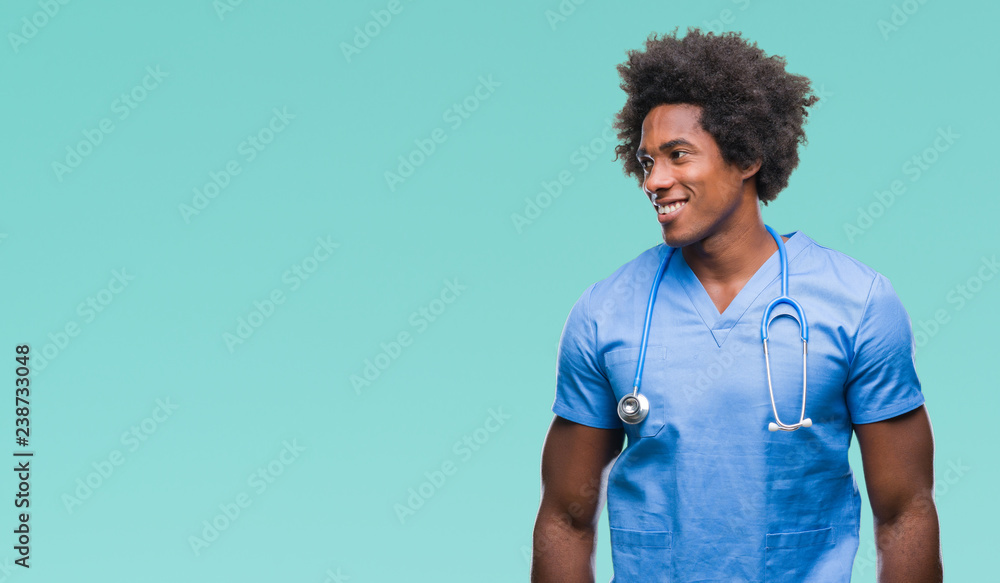 Afro american surgeon doctor man over isolated background looking away to side with smile on face, natural expression. Laughing confident. Afro american surgeon doctor man over isolated background looking away to side with smile on face, natural expression. Laughing confident.