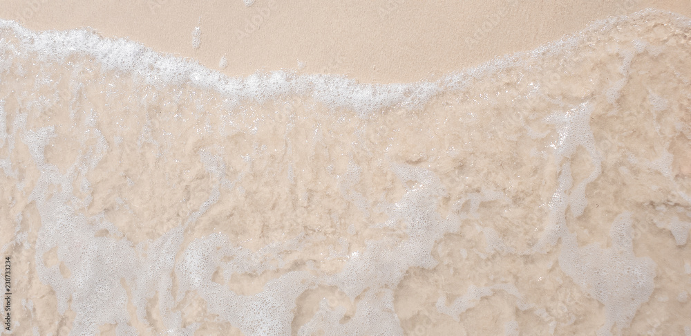 white ocean wave on sandy beach in summer vacation copy space for your text