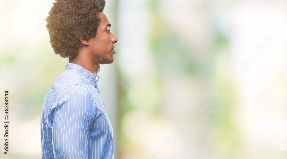 Afro american man over isolated background looking to side, relax profile pose with natural face with confident smile. Afro american man over isolated background looking to side, relax profile pose with natural face with confident smile.