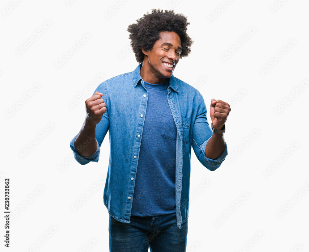 Afro american man over isolated background very happy and excited doing winner gesture with arms raised, smiling and screaming for success. Celebration concept. Afro american man over isolated background very happy and excited doing winner gesture with arms raised, smiling and screaming for success. Celebration concept.