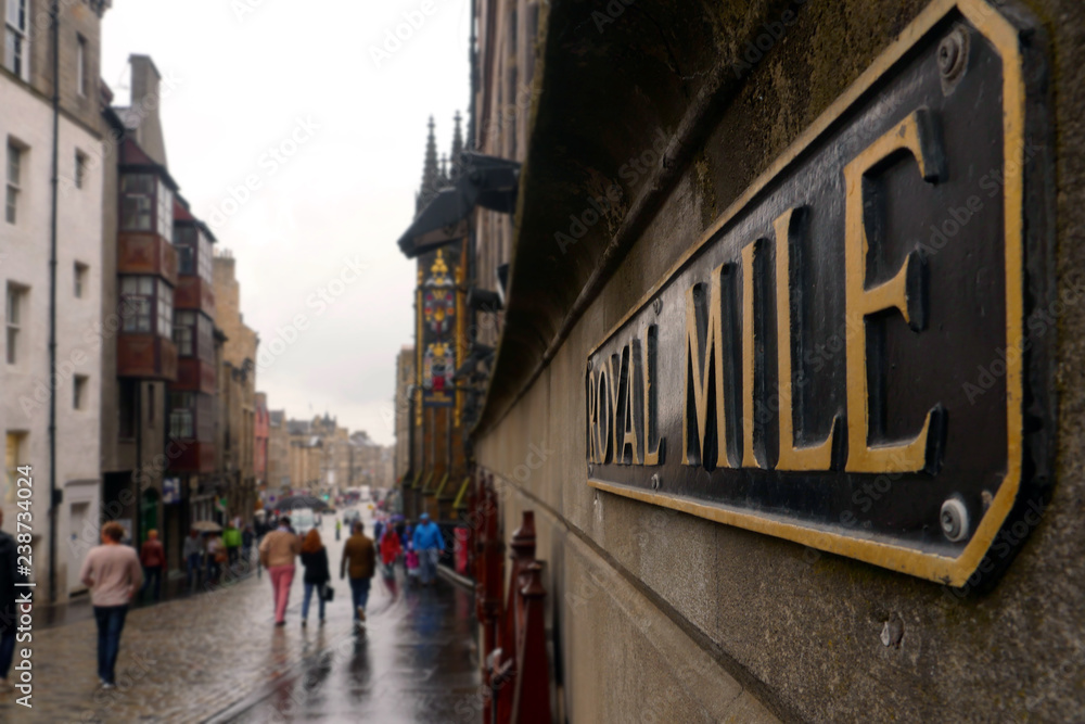 Edinburgh, Scotland / United Kingdom - August 2014: Royal Mile sign in the foreground and the street unfocussed in the background