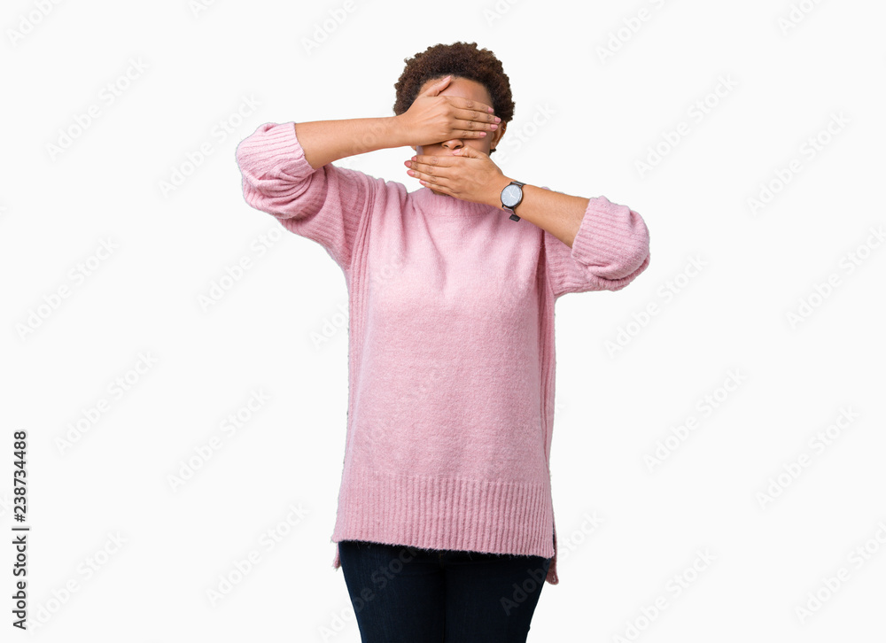 Beautiful young african american woman over isolated background Covering eyes and mouth with hands, surprised and shocked. Hiding emotion Beautiful young african american woman over isolated background Covering eyes and mouth with hands, surprised and shocked. Hiding emotion