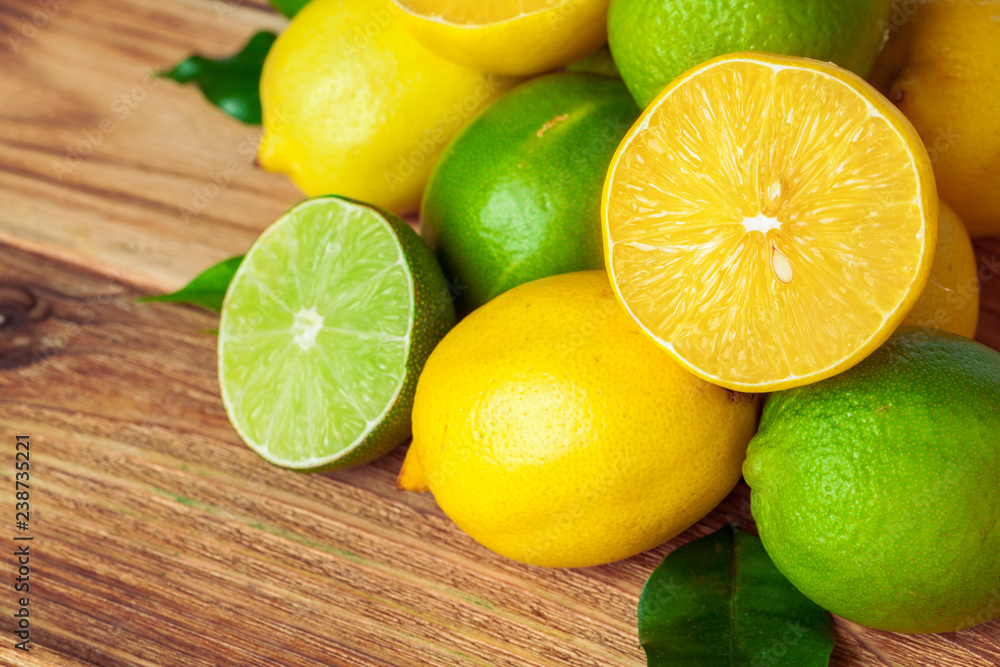 lemons and limes on wooden pad lemons and limes on wooden pad