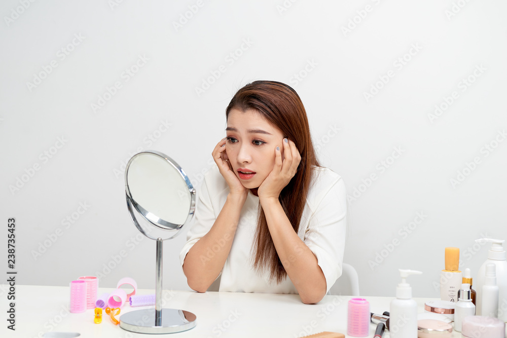 Young woman checking her skin. Skin care concept. Young woman checking her skin. Skin care concept.