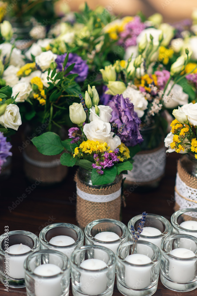 Beautiful flower decorations with candles for the wedding ceremony.