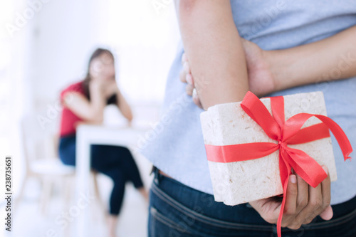 Boyfriend prepare gift to surprising girlfriends. Romantic husband and love concept