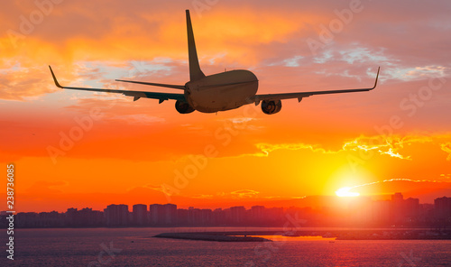 Airplane take off from the airport - Travel by air transport  photo
