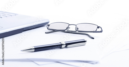 closeup. notebook ,glasses and pen on the workplace of the busin