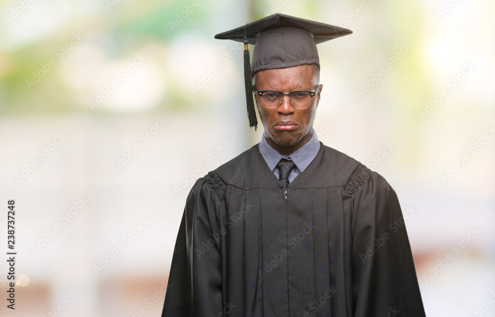 Young graduated african american man over isolated background depressed and worry for distress, crying angry and afraid. Sad expression.