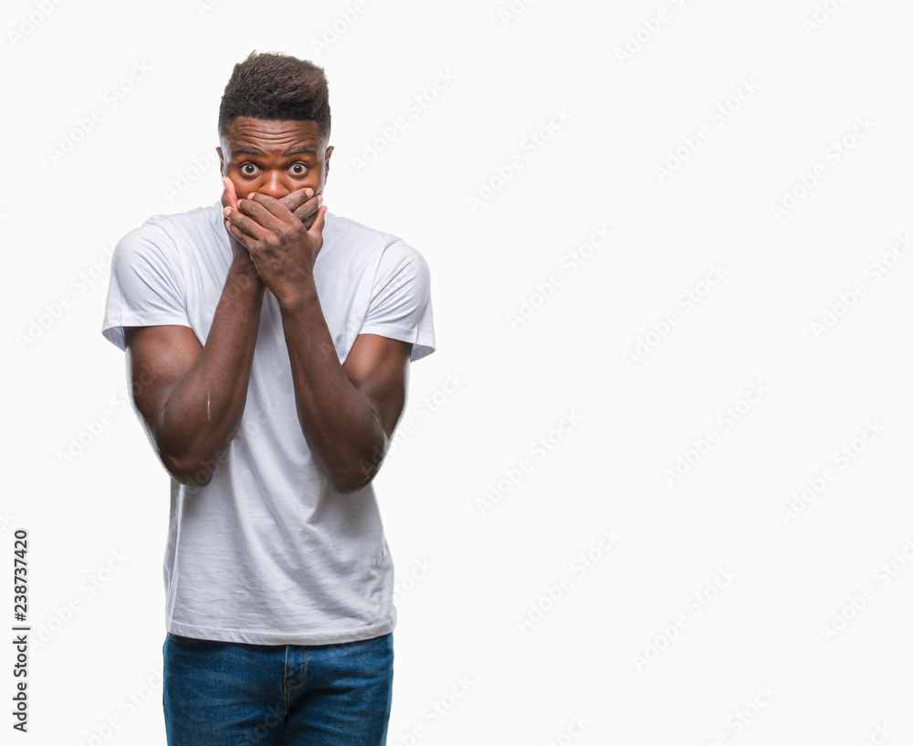 Fototapeta premium Young african american man over isolated background shocked covering mouth with hands for mistake. Secret concept.