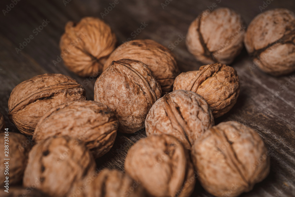 close up view of walnuts on wooden tabletop close up view of walnuts on wooden tabletop