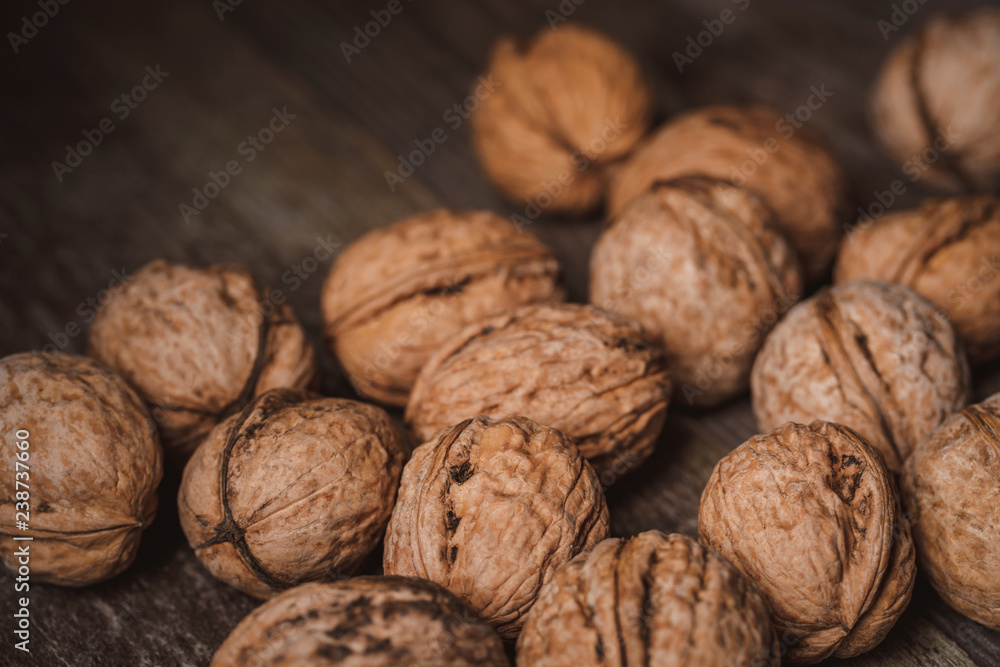 close up view of walnuts on wooden tabletop close up view of walnuts on wooden tabletop