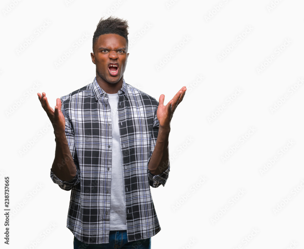 Fototapeta premium Young african american man over isolated background crazy and mad shouting and yelling with aggressive expression and arms raised. Frustration concept.