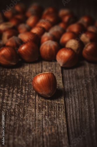 close up view of shelled hazelnuts on wooden backdrop