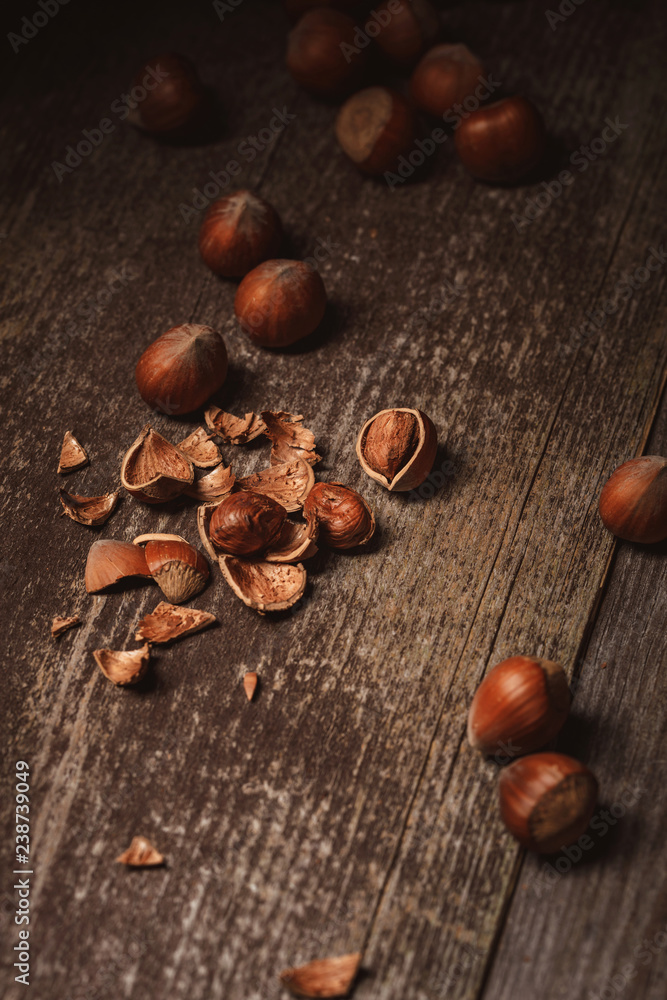 close up view of shelled hazelnuts and husk on wooden tabletop close up view of shelled hazelnuts and husk on wooden tabletop