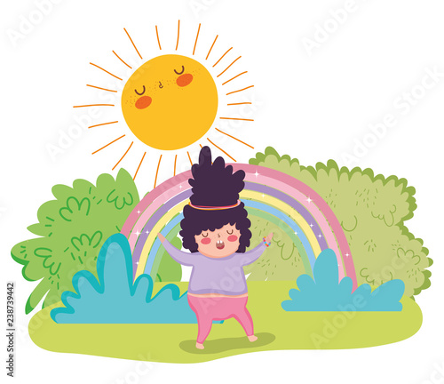 girl playing in the bushes wth rainbow and sun