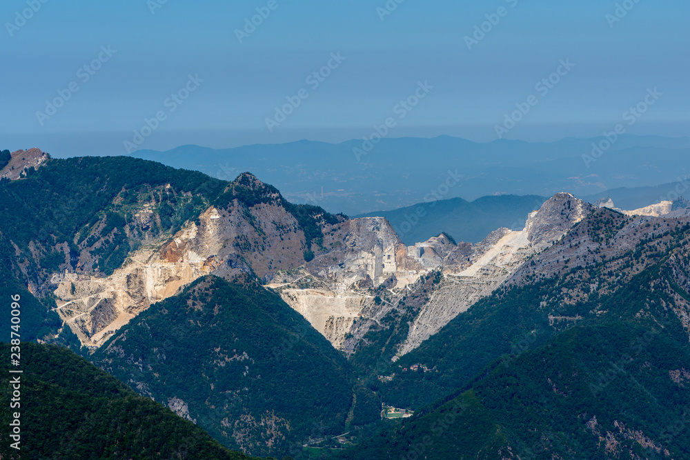 Carrara marble dimension stone pit career in Apuan Alps Massa area, Toscana, Italy, on a clear summer day