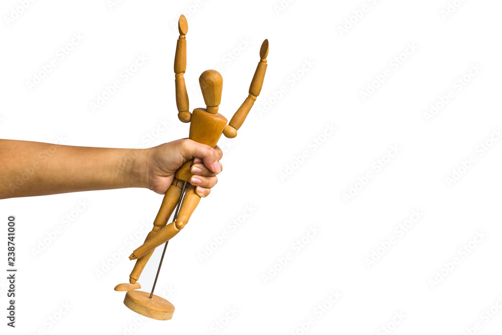 A cropped of female hand holding wood mannequin isolated on white background include clipping path. A cropped of female hand holding wood mannequin isolated on white background include clipping path.