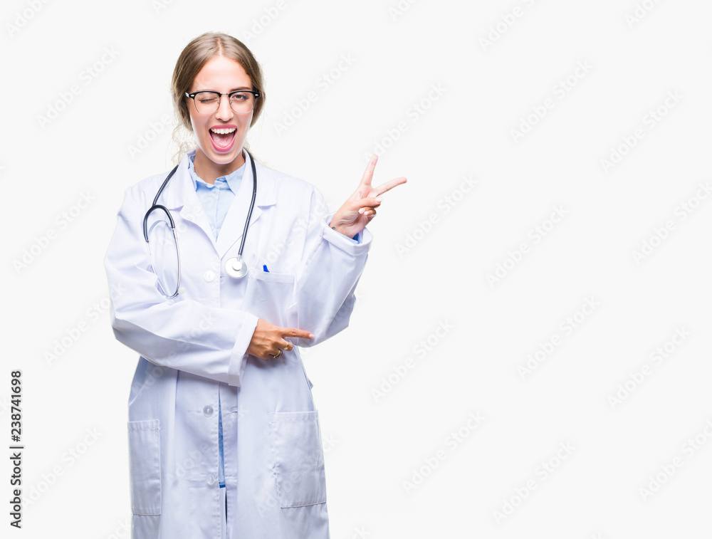 Beautiful young blonde doctor woman wearing medical uniform over isolated background smiling with happy face winking at the camera doing victory sign. Number two. Beautiful young blonde doctor woman wearing medical uniform over isolated background smiling with happy face winking at the camera doing victory sign. Number two.