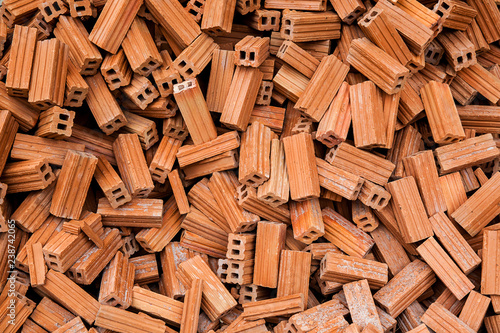 group of bricks square construction materials. bricks texture and abstract in vignette for background or copy space for text fill. Stack of disorganized brown bricks.