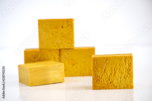 Natural handmade yellow soap bars isolated on white