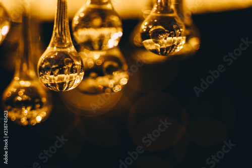  abstract blurry glowing lights of a crystal lamp. Warm light glass.